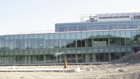 Office building with construction. Construction area with fence near business ce Stock Footage 244246598