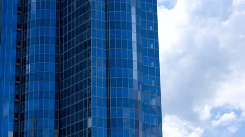 Office building facade with blue sky reflections in the glass Stock Footage 7760438