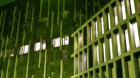 Office building at night; building facade with glass and lights. Stock Photos