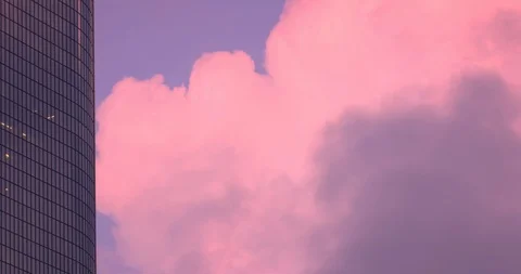 Office building windows with dramatic pink clouds passing 4K Stock Footage 120868503