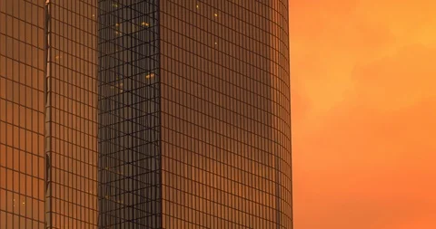 Office building windows with dramatic sunset clouds passing 4K Stock Footage 120868474