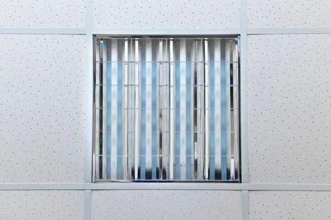 Office ceiling with square light fixture and fluorescent lights. Daylight lam Stock Photos