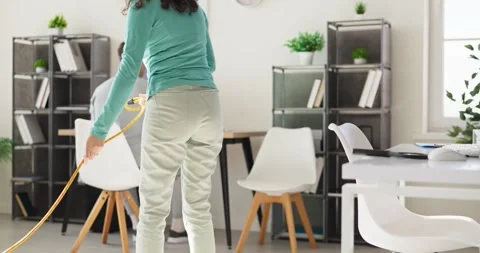 Office cleaning service worker mopping modern workspace for hygiene and safety Stock Footage 345935483