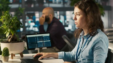 Office clerk at computer desk reading documentation files, solving tasks Stock Footage 305752261