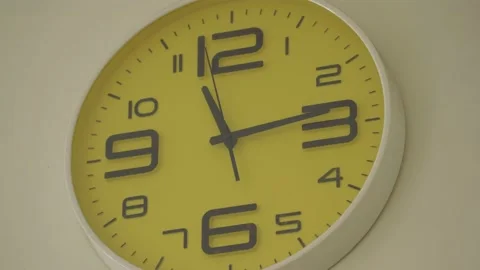 Office clocks on yellow wall Stock Footage 143373461