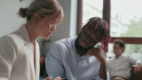 Office co-worker with coffee mug talks at meeting room space. Confident teamwork Stock Footage 199485299
