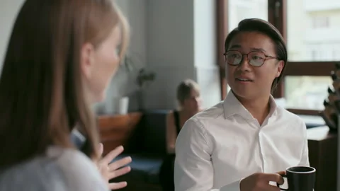 Office co-worker with mug talks at meeting room. Friendly teamwork of asian man Stock Footage 199485444