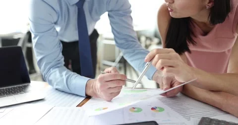 Office colleagues discuss report solving business problem Stock Footage 317166838