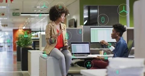Office colleagues tapping tablet, causing green UI icons marking laptop data, Stock Footage 329832540