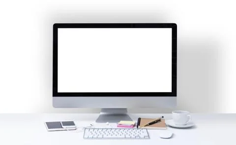 Office desk with computer screen, keyboard, mouse, stationary and coffee cup Stock Photos
