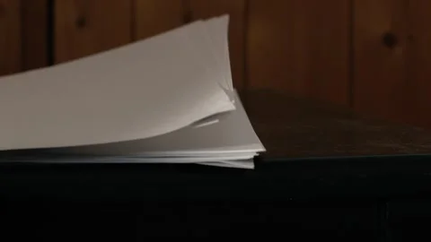 Office desk fan blowing notepad paper Stock Footage 252140152