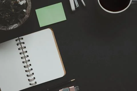 Office desk with notepad, coffee, leaf and pen.Top view 스톡 사진