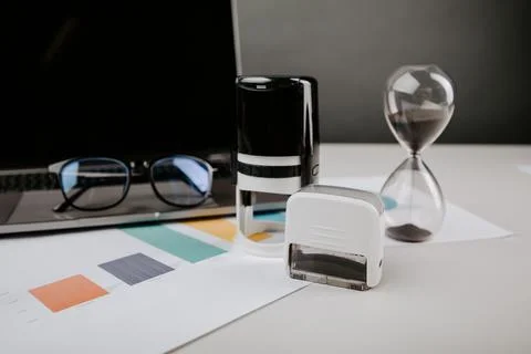 Office desk table with analysis chart, laptop, glasses and stamp Stock Photos