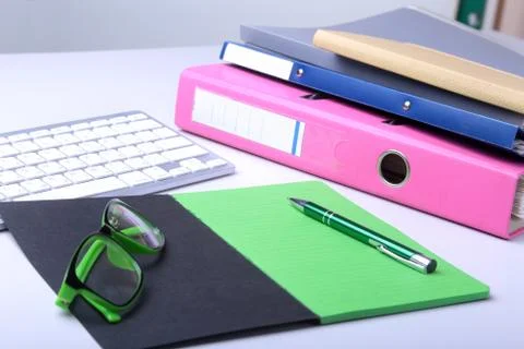 Office desk table with blank notebook, keyboard, other supplies and coffee cup Stock Photos