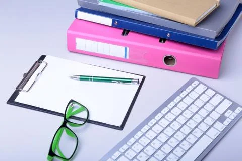 Office desk table with blank notebook, keyboard, other supplies and coffee cup Stock Photos
