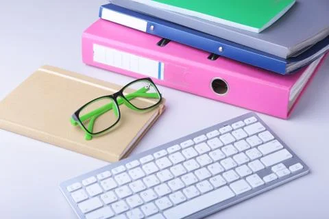 Office desk table with blank notebook, keyboard, other supplies and coffee cup Stock Photos