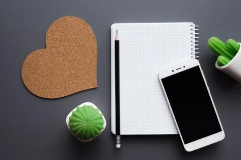 Office desk table with blank notepad, smartphone and cacti Stock Photos