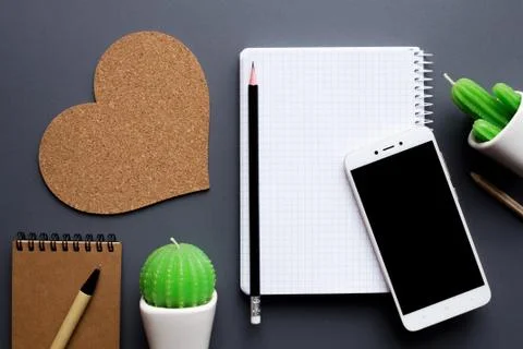 Office desk table with blank notepad, smartphone and cacti Stock Photos