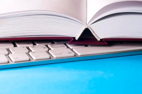 Office desk table with computer, books, a magnifying glass and pen. Stock Photos