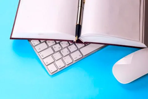 Office desk table with computer, books, a magnifying glass and pen. Stock Photos
