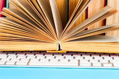 Office desk table with computer, books, a magnifying glass and pen. Stock Photos