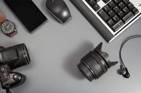 Office desk table with computer, camera, mouse. Top view with copy space. Stock Photos