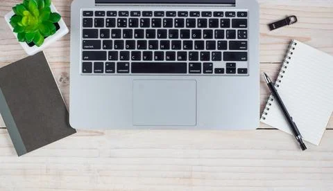 Office desk table with computer, flash drive, note paper and flower. Top vi.. Stock Photos