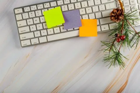 Office desk table with computer keyboard and christmas tree branch decoration Stock Photos