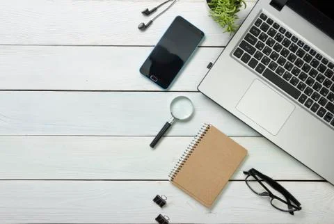 Office desk table with computer, supplies, flower. Top view. Copy space for text Stock Photos