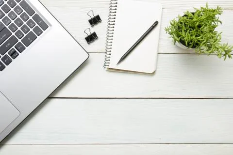 Office desk table with computer, supplies, flower. Top view. Copy space for text 库存照片