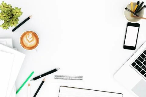 Office desk table with labtop computer,blank magazine smart phone and coffee cup Stock Photos