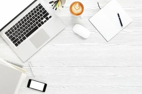 Office desk table with labtop computer,blank magazine smart phone and coffee cup Stock Photos