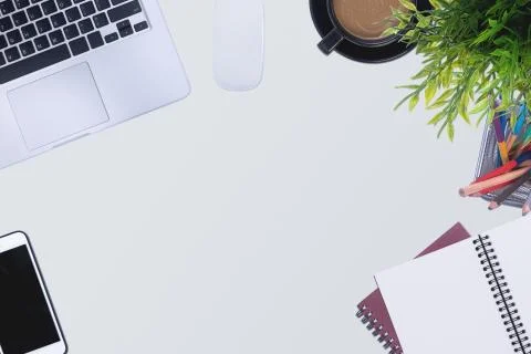 Office desk table with laptop computer and supplies. Stock Photos