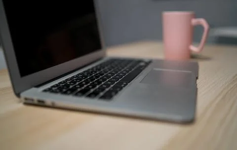 Office desk table with laptop computer and flower. Top view with copy space 库存照片