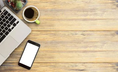 Office desk table with laptop computer,smart phone, cup of coffee and cactus. Stock Photos