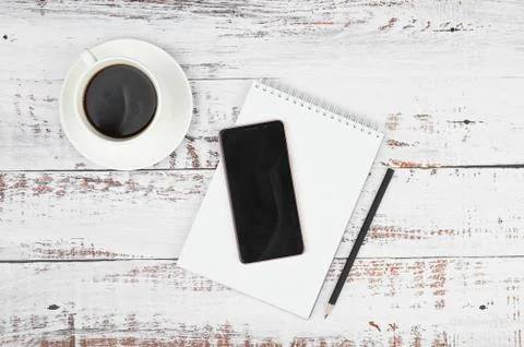 Office desk table with note pad, pencil and cup of coffe. Top view with copy  Stock Photos