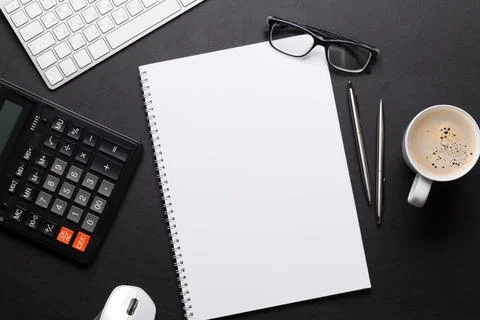Office desk table with pc, notepad, glasses, coffee Stock Photos