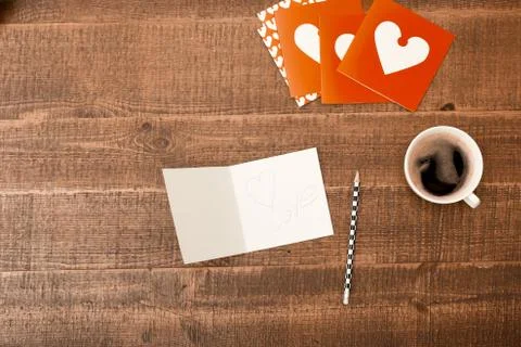 Office desk table. Top view with blank greeting card, pencil and coffee on wo Stock Photos