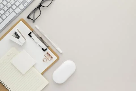 Office desk table top view with office supply, beige table with copy space, b Stock Photos
