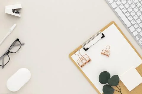 Office desk table top view with office supply, beige table with copy space, b Stock Photos