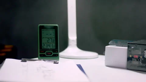 Office desk with work-related tools by table-lamp in evening Stock Footage 275238481