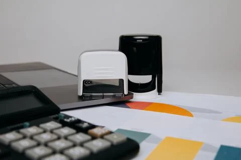 Office desktop with documents and a stamp of organisation Stock Photos