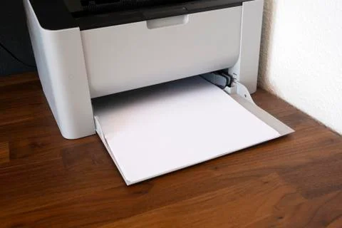 Office digital printer, copier and paper on wooden desk, fax machine close-up Stock Photos