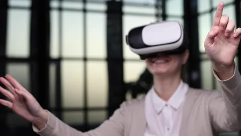 Office employee having fun at work, watching 3D video in virtual reality glasses Stock Footage 240416089