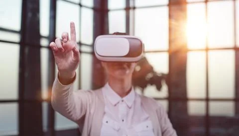 Office employee having fun at work, watching 3D video in virtual reality glasses Stock Photos
