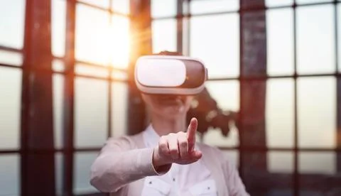 Office employee having fun at work, watching 3D video in virtual reality glasses Stock Photos