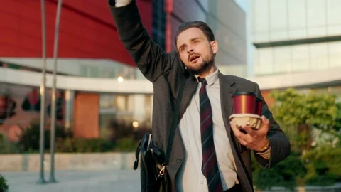 Office employee hustling to work while chatting on phone and carrying coffee Stock Footage 312878389