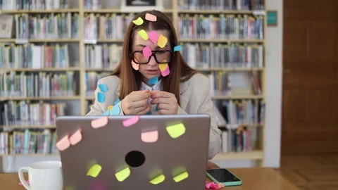 Office employee overwhelmed by sticky note reminders and endless tasks Stock Footage 341657190