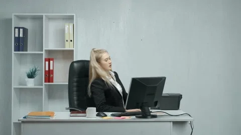 An office employee performs work on a computer. A girl repairs a broken print Video stock 150122400