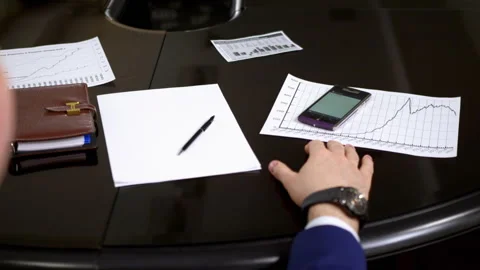 Office employee takes calling cell phone during meeting Stock Footage 246666929